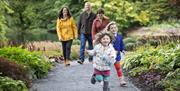 Photograph of a family walking through trails and gardens on Montalto Estate, Ballynahinch.