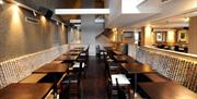 Dining area with many tables and chairs.