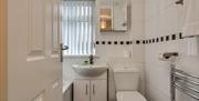 A photo of a bathroom with a bath, sink and toilet.