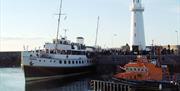 Boats moored on Donaghadee Pier beside the  lighthouse