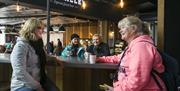 Customers enjoying coffee sitting at The Gallery Café at Titanic Belfast