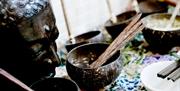 Statue and bowls with incense