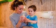 Photo of mother and son holding  Chicks at the Ark Open Farm