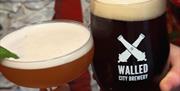 A cocktail and stout beer chearsing from Walled City Brewery