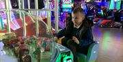 Little Boy enjoying the Amusements Arcade at Airtastic Lisburn