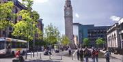 The Albert clock rising above the surrounding busy Belfast city area.