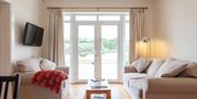 Main Lounge with patio doors and view over fields.