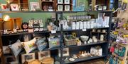 Various shelves of gift items including cushions and candles
