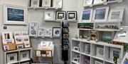 Range of various sizes of art mounted on walls and shelves