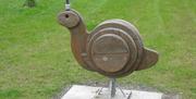 A wooden sculpture of a snail.