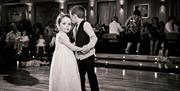 Black and white image of two children dancing together