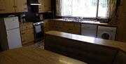 Kitchen area with wooden cabinets and table and chairs