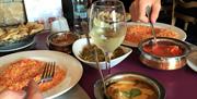 An Indian meal of curry and rice on a restaurant table