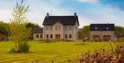 Outside view of 2 storey house with double garage and large garden