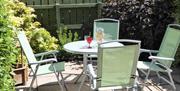 rear yard with glass table  and outdoor chairs