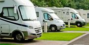 Image shows row of caravans parked