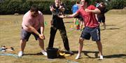 Image shows males exercising in a field