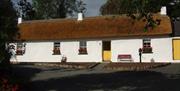 Outside image of cottage with yellow doors