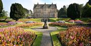 Image of the Town Hall and front gardens in red, pink and yellow bloom