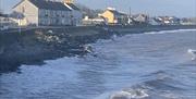 View of house from beach with nice waves