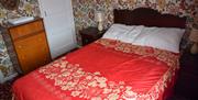 1960s style bedroom containing a double bed and chest of drawers