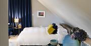 King sized bed with white linen