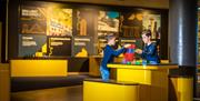 Two young boys are building a tower of blocks at a W5 exhibition