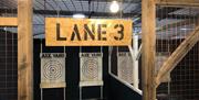 An axe throwing lane labeled lane 3 with targets.