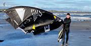 A kite surfer on the beach