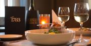 A plate of food and wine glasses