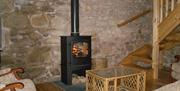 living area with wood burning stove and armchairs