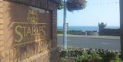 Entrance stone and brick sign for The Stables