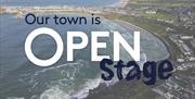 text reads 'Our Town is Open stage' overlayed on an aerial image of Portrush