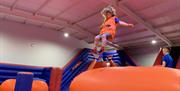 A young girl bouncing in the Airtastic Inflata park.