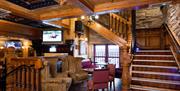 Cosy seating area below a sports screen in the lower lounge of Charlie's bar Enniskillen