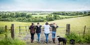4 ladies standing in contemplation overlooking fields at City of Derry Farm and Equestrian Centre
