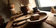 A photo of some museum articles on display. Items from the 1910's era commonly used by the fisherman and his family who lived in Cockle Row Cottages.