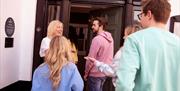 Group being greeted by the instructor as part of the Dancing at the Crossroads experience