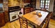 Image shows kitchen area with table and 6 chairs