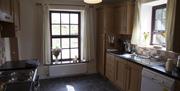 kitchen area with wooden cabinets and windows outlooking mountains