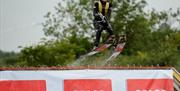 Image is of water-skier taking a jump