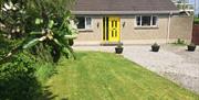 Outside image of house with yellow door