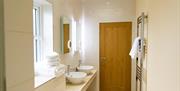 Image of a cream bathroom with his and hers sinks