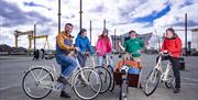 Steven stops his tour group on the Titanic Slipways with the Titanic Visitor Centre in the background.