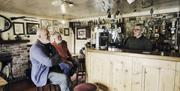 2 people at the bar chatting to the barman in Billy Andys