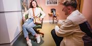 Couple take a photo amongst props from the show Derry Girls