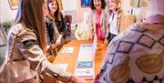 Group of women have a laugh as they admire the Derry Girls props