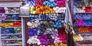 Interior of Lighthouse Yarns with multi colour wools displayed on shelves