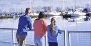 A family looking over the marina at boats