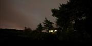 The Beach Hut from outside on an evening, with the lights on